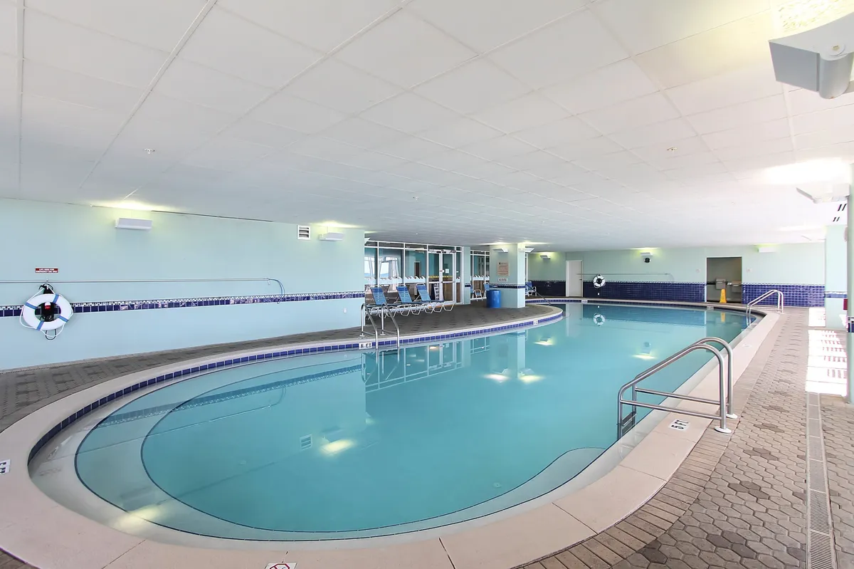 A vibrant pool area with sparkling water, lounge chairs, and a lifebuoy, inviting guests to relax and socialize poolside. The scene is perfect for poolside lounging, group hangouts, and friendly competitions.